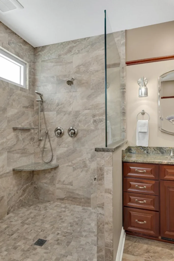 Modern walk-in shower with marble tile, rainfall head, and handheld sprayer